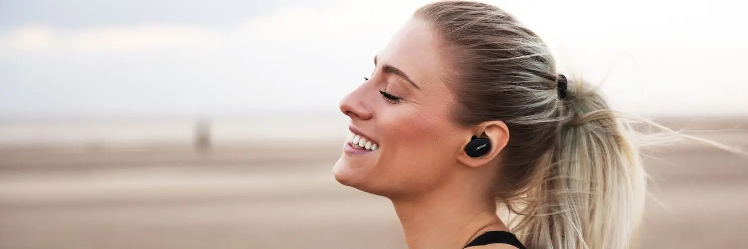 Woman wearing Bose earbuds